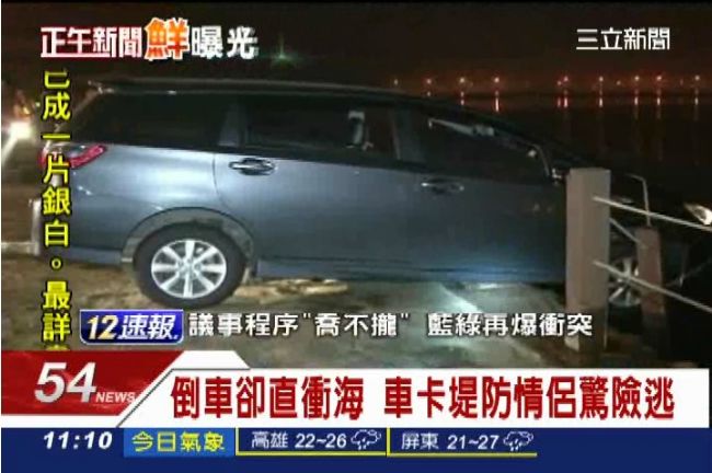 倒車卻直衝海　車卡堤防情侶驚險逃