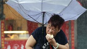 台灣大媽雨中吃肉包（圖／美聯社／達志影像）