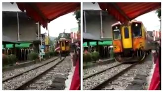 火車進站前一刻　三寶撐陽傘穿過鐵軌