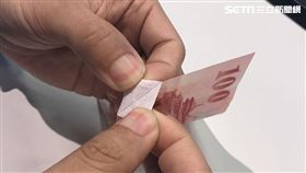 百元鈔輕易被剖成兩半。