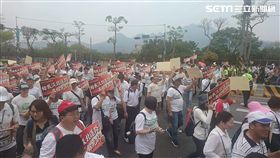 淡水居民川著白色上衣高舉「給我淡北道路，其餘免談！」的海報，上街遊行表達訴求。（圖／記者游承霖攝）