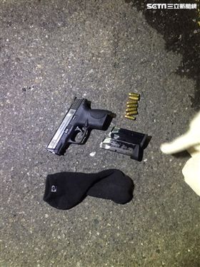 警方在副駕駛座的一隻襪子內起出一把制式手槍。（圖／翻攝畫面）