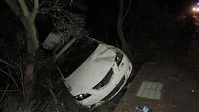 少年無照駕車過彎失控  釀2死3傷（2）胡姓少年9日凌晨無照駕車載4名未成年高職生，到台中東海商圈吃消夜，返家途中疑似過彎車速過快，車輛先失控撞擊路旁電線桿，再衝進一旁邊坡的草叢後翻覆，轎車因強烈撞擊力凹陷變形，造成2死3傷，詳細事故原因仍在調查中。（翻攝照片）中央社記者蘇木春傳真  107年8月9日