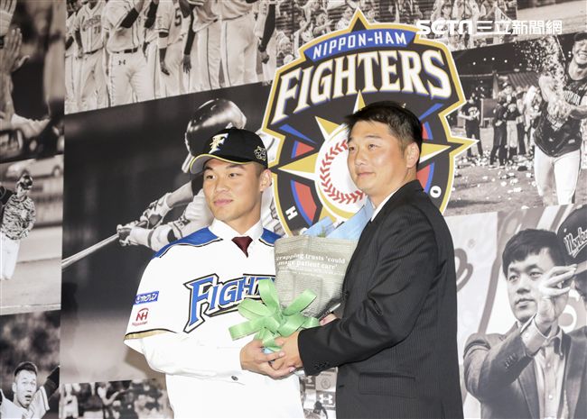 台灣強打王柏融與日本職棒火腿隊簽約，桃猿打擊教練曾豪駒獻花祝福。（記者林士傑/攝影）