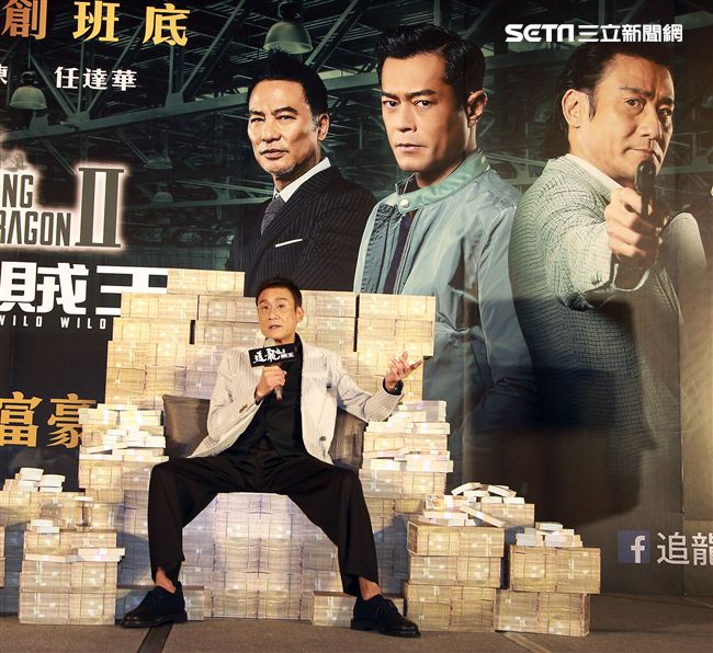 梁家輝出席電影「追龍II賊王」記者會，霸氣帥坐在鈔票椅瀟灑狂噴鈔票，展現史上最強悍匪氣魂。（記者邱榮吉/攝影）