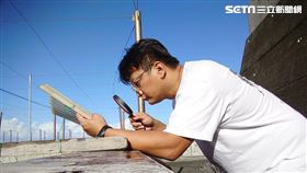 復育人員正用放大鏡觀察九孔寶寶攝食狀況。（圖／新北市漁業處提供）