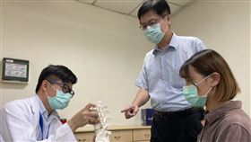 光田綜合醫院骨科醫師許芳偉(左)向民眾說明脊椎側彎情形，圖中人非個案當事人（圖／光田綜合醫院提供）