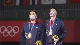東奧羽球男雙台灣奪金寫歷史東京奧運羽球男子雙打賽程31日晚間告一段落，台灣「麟洋配」搭檔李洋（左）、王齊麟（右）勇奪台灣奧運羽球史上首面金牌，賽後兩人注視中華隊旗在場中緩緩高升。中央社記者吳家昇攝  110年7月31日