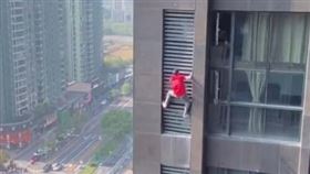 ▲杭州一名空調維修工人徒手攀在17樓外面維修。（圖／翻攝自微信）
