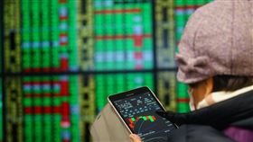 台股震盪收黑（3）台北股市12日開低震盪走低，投資人拿著平版電腦緊盯盤勢，指數終場下跌56.60點，收在15500.70點。中央社記者王騰毅攝  110年1月12日