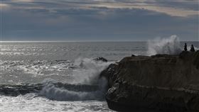 東加海底火山噴發，連美國西岸也發布海嘯警報。圖為美國民眾在加州聖克魯斯（Santa Cruz）的燈塔觀看巨浪撞擊。（圖／美聯社／達志影像）