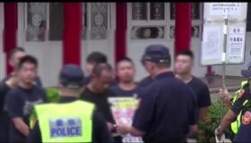 中山分局長陳金城舉牌警告，角頭等人立即解散離開。（圖／警方提供）