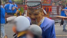 機車雙載的夫妻遇到難關，土地公持續緊盯，幾乎整張臉都要貼到騎士安全帽上。（圖／翻攝自@lai._.1114 Threads）
