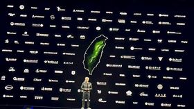 ▲黃仁勳來台演講時，在舞台上展示合作夥伴的背板牆， 00922相關的成分股占比權重近七成。（圖／記者余國棟攝影）