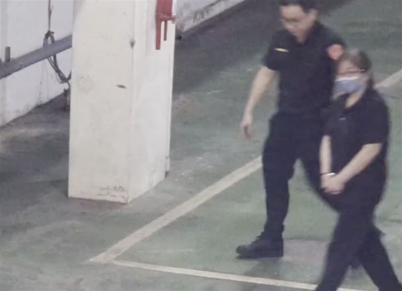 黃呂錦茹走下囚車,聽到車道外媒體喊話提問,看了車道大門一眼。(圖/翻攝畫面)