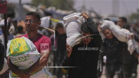 ▲巴勒斯坦人在加薩走廊攜帶由加薩人道主義基金會發放的物資。（圖／翻攝自美聯社）