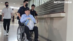 ▲結束11個月羈押，沈慶京坐輪椅離開台北地院。右腳看得到戴上電子腳鐐。（圖／記者楊佩琪攝）
