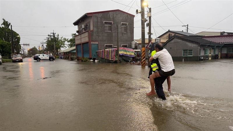 南部不少民宅淹水，在地警員協助長輩撤離，圖為台南市後壁區。（圖／翻攝畫面）