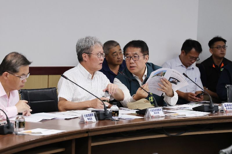 行政院災害復原前進指揮所指揮官陳金德(左2)與台南市長黃偉哲(持紙張者)談話。(圖/中央社)