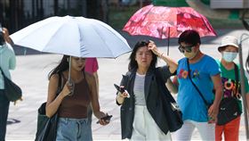 氣象署發布高溫資訊（2）中央氣象署15日發布高溫資訊，台北市、新北市為黃色燈號，注意攝氏36度以上高溫，預防熱傷害。圖為新北市板橋區外出民眾撐傘遮陽。中央社記者王騰毅攝  114年7月15日