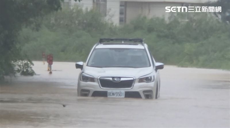 恆春工商後方道路淹水超過一個輪胎,駕駛趕緊下車保平安。(圖/翻攝畫面)