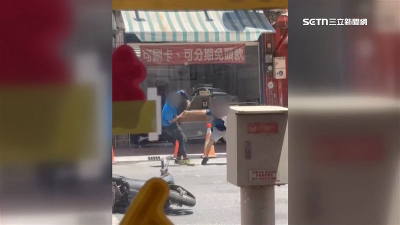 不顧手上還抱著孩子，2男當街拿著鐵條互毆