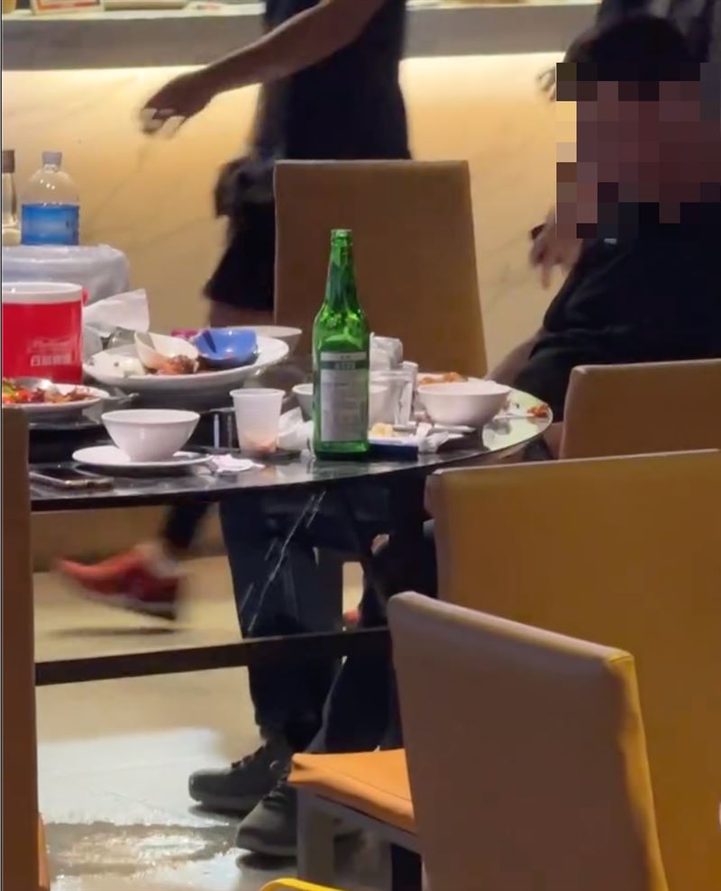 黑衣男直接在餐廳座位上小便，路人目擊傻眼。（圖／翻攝Threads）