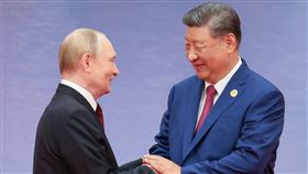 習近平與普丁會面時打破嚴肅形象，展現難得笑容。（圖／路透社／達志影像）