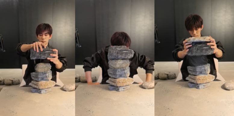 這場僅持續約17分鐘的直播，吸引千萬人次觀看，內容卻讓人感到不安，易烊千璽全程表情低落，幾乎沒有與粉絲互動，更不見任何預設橋段，他默默將石頭一塊塊堆疊，口中只淡淡吐出「好無聊」幾個字。（圖／翻攝自易烊千璽IG）