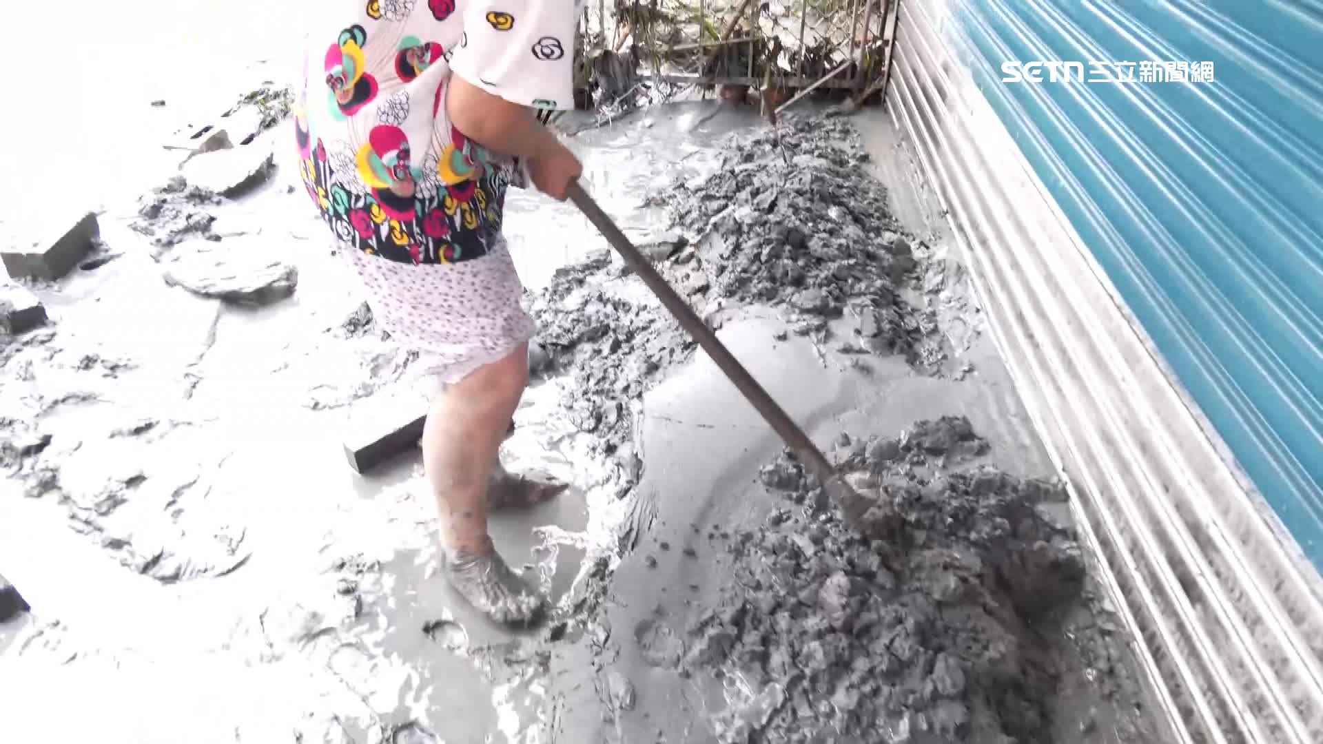 滿滿的淤泥，民眾脫鞋拿起工具清理家園