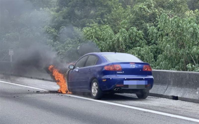 藍色轎車因不明原因車頭竄濃煙火舌。（圖／翻攝畫面）