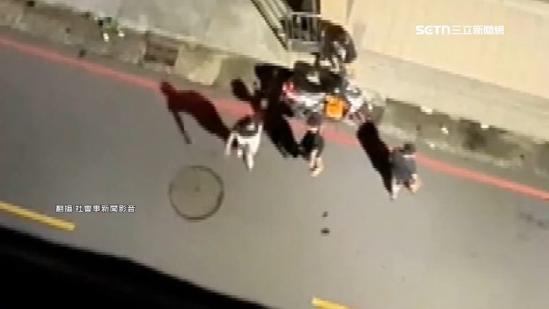 駕駛下車與一群年輕人在路邊交談
