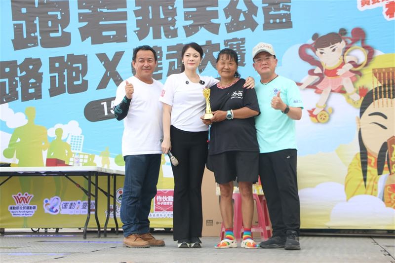 超跑媽「帶」小比第一次１個人跑，完成與兒子的最後約定，神情落寞令網友不捨淚崩。圖為超跑媽「一個人」接受獎盃。（圖／翻攝自《小比的跑旅雜記》、黃嫈珺議員提供）