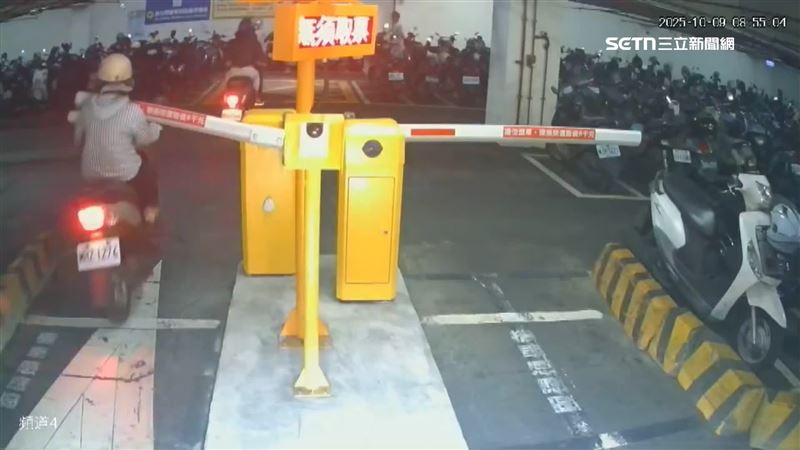 停車場驚險!騎士跟太近 遭柵欄打中重摔