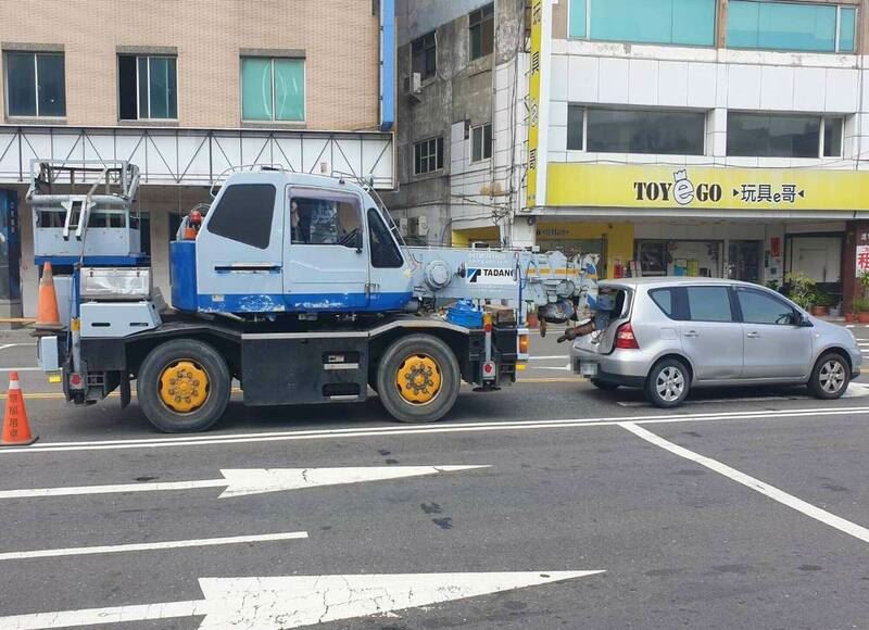 大吊車吊臂直接插入後座空間，造成玻璃破大洞。（圖／翻攝畫面）