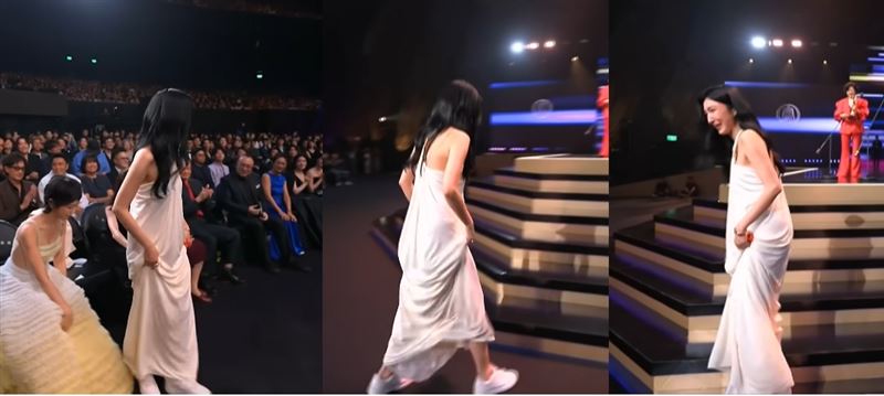 楊謹華上台時提起褲裙露出小白鞋，尷尬轉身笑說「都換鞋了！」。（圖／翻攝自金鐘獎YouTube）