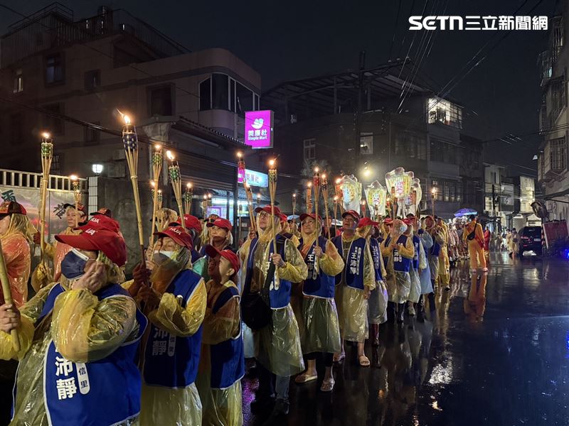 風雨夜中火把閃爍,信眾恭迎太子爺聖駕。(圖/寶島神很大直播畫面截圖)
