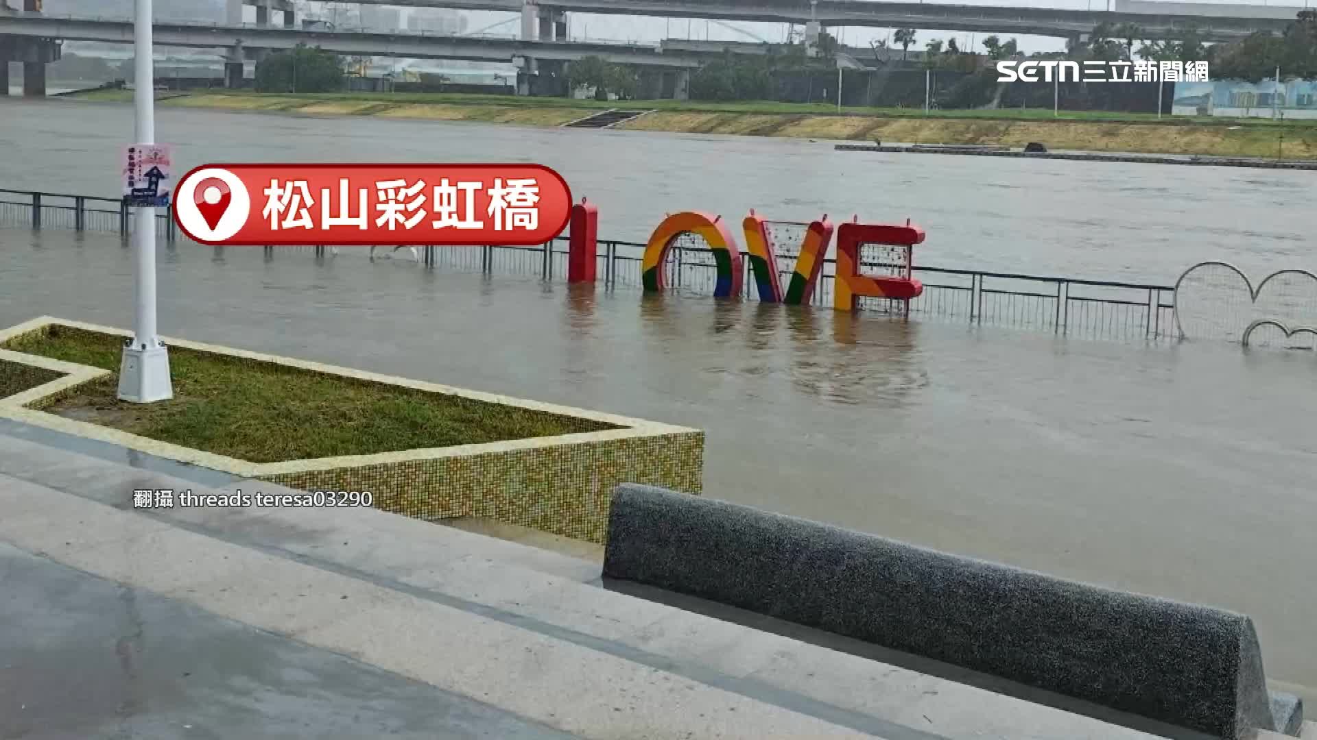 松山彩虹橋附近的溪水水位高到淹過河堤，LOVE字樣幾乎被淹過一半。（圖／翻攝自Threads @teresa03290）