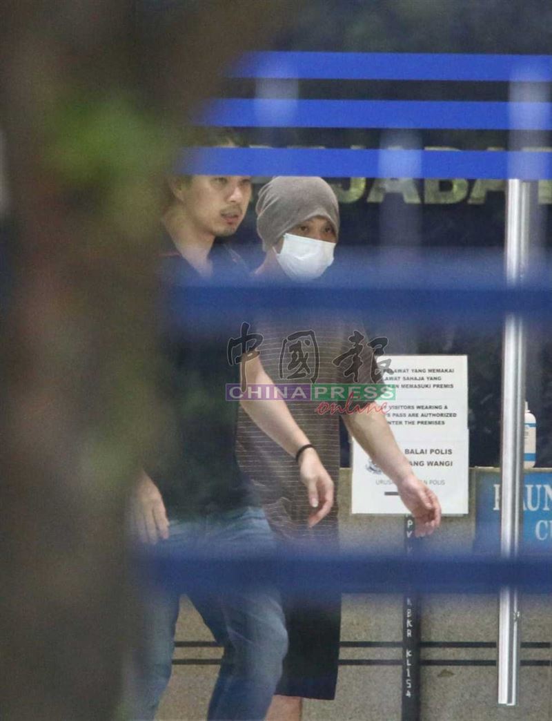 黃明志（右）在律師陪同下離開警局。（圖／《中國報》提供）