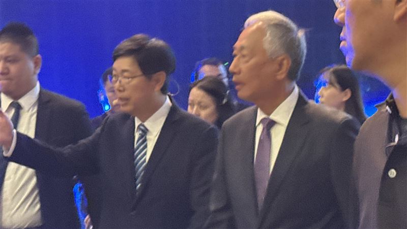 郭台銘時隔3年重返鴻海科技日，服喪期白髮現身、未致詞僅鞠躬致意，劉揚偉開場感謝其創業打底與支持。郭全程台下聽講並與劉低聲交流，畫面對比2021首屆科技日他生日駕Model E登場、宣示MIH電動車雄心，象徵精神續航再起。（圖／記者師瑞德攝影）