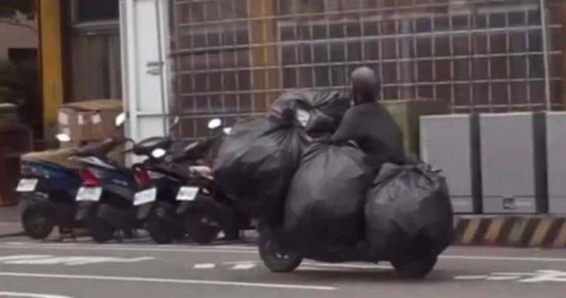 高雄騎士車上掛滿5大袋疑似資源回收物，警方透過網路畫面主動開罰。（圖／翻攝畫面）