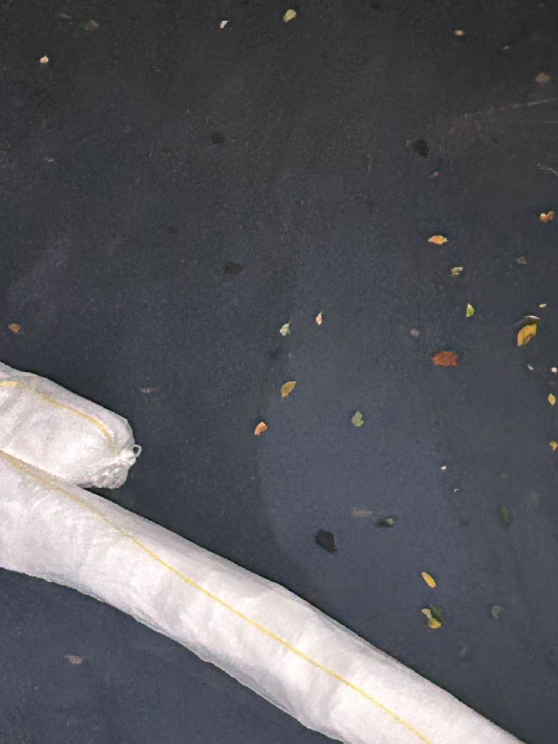 基隆市暖暖區源遠路102巷溝渠2日發現新污染物（圖），台灣自來水公司初步判斷為油品，呈現白色乳化狀態。（基隆市政府提供）