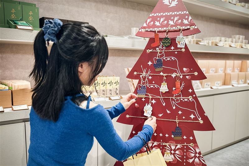 阿原的客人將許願卡掛在許願樹上。（圖／品牌業者提供）