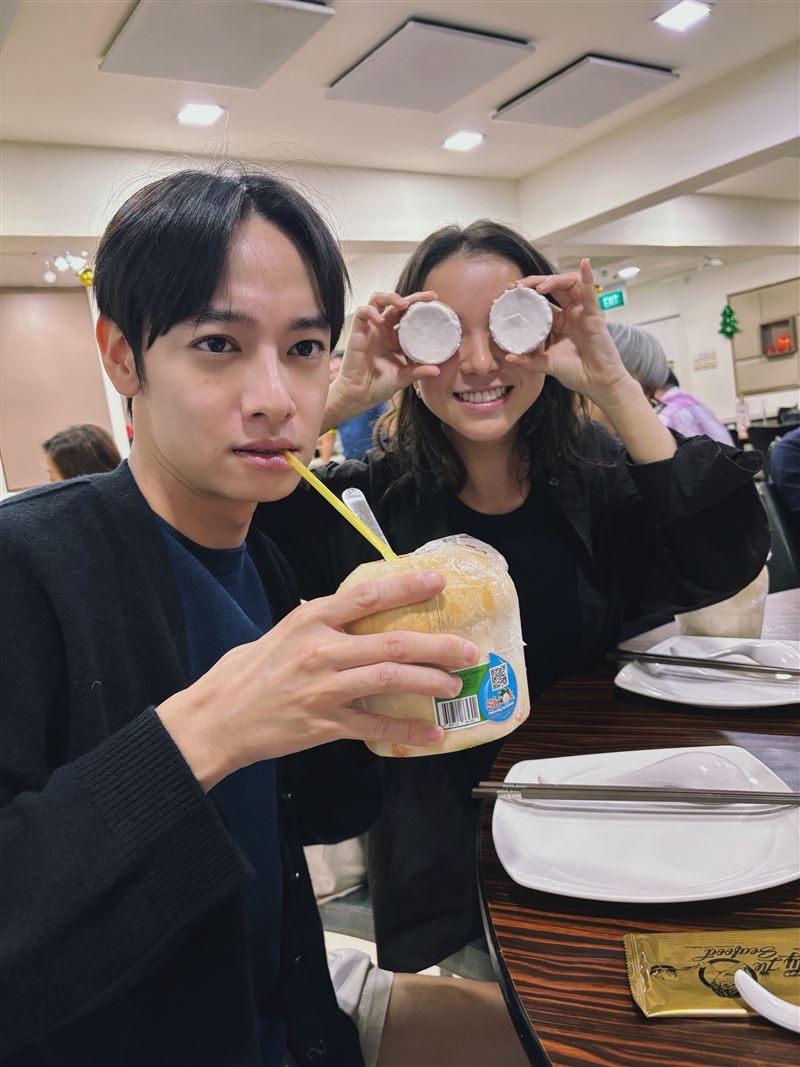 劉修甫(左)、項婕如在新加坡喝椰子水搞怪拍照。(圖/三匠影視提供)