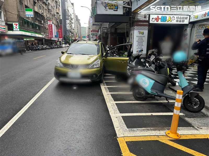 北市張婦下車問路卻未拉手煞車,結果車輛倒退滑行撞翻7輛機車。(圖/翻攝畫面)