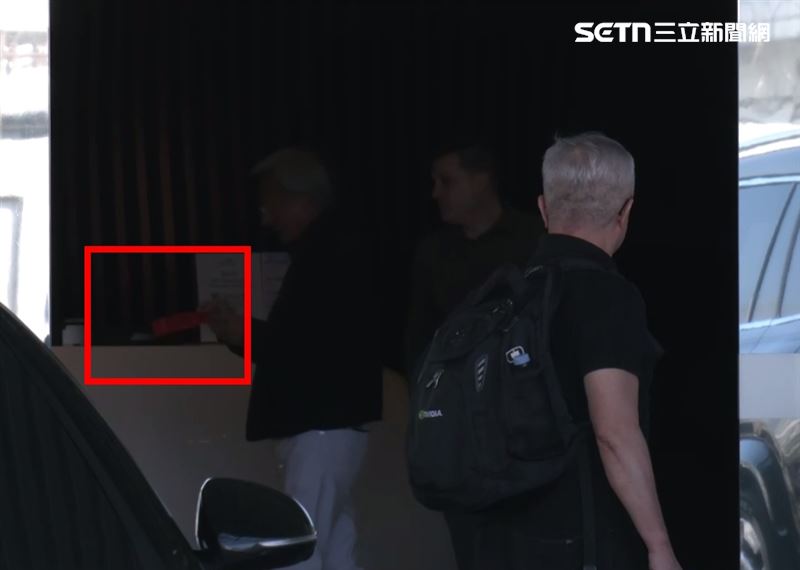 黃仁勳還沒走出大門前，就已展現十足親和力，不僅發送紅包給機場地勤人員，甚至手提兩大袋「三明治」與「養樂多」，分送給在場的記者與粉絲。（圖／三立新聞）