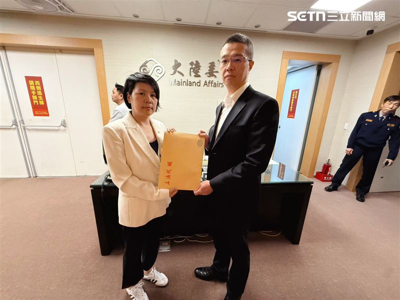 李貞秀委員遞交文件資料給陸委會法政處長周鳴瑞（圖／民眾黨團提供）