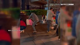 台北101前有發財水　一群人晚間瘋舀水