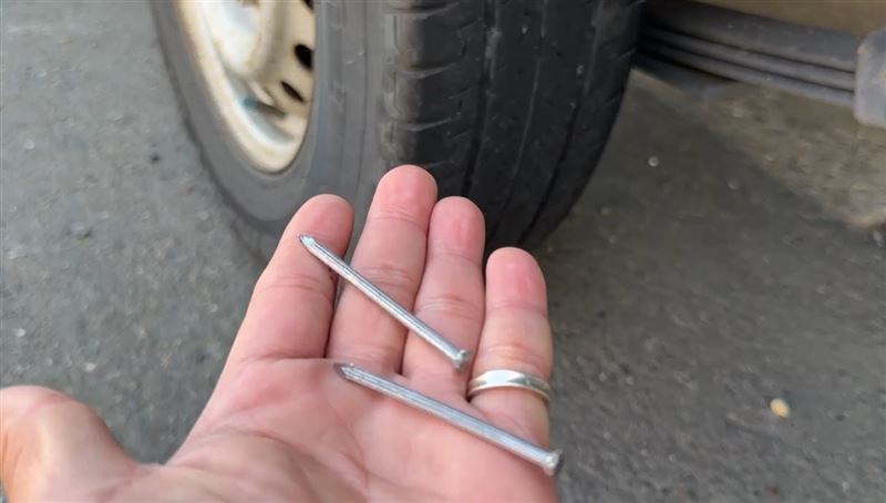 長達6公分的釘子初估有近百支散落在路面，警方將調閱路口監視器追查釘子來源。(圖／翻攝畫面)