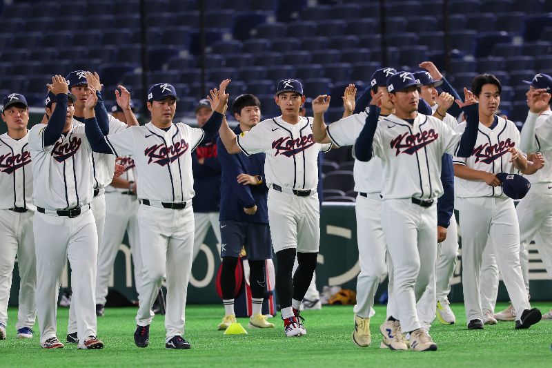 經典賽韓國隊4日在日本東京巨蛋練球，隊長李政厚（中）與隊員們在場上暖身